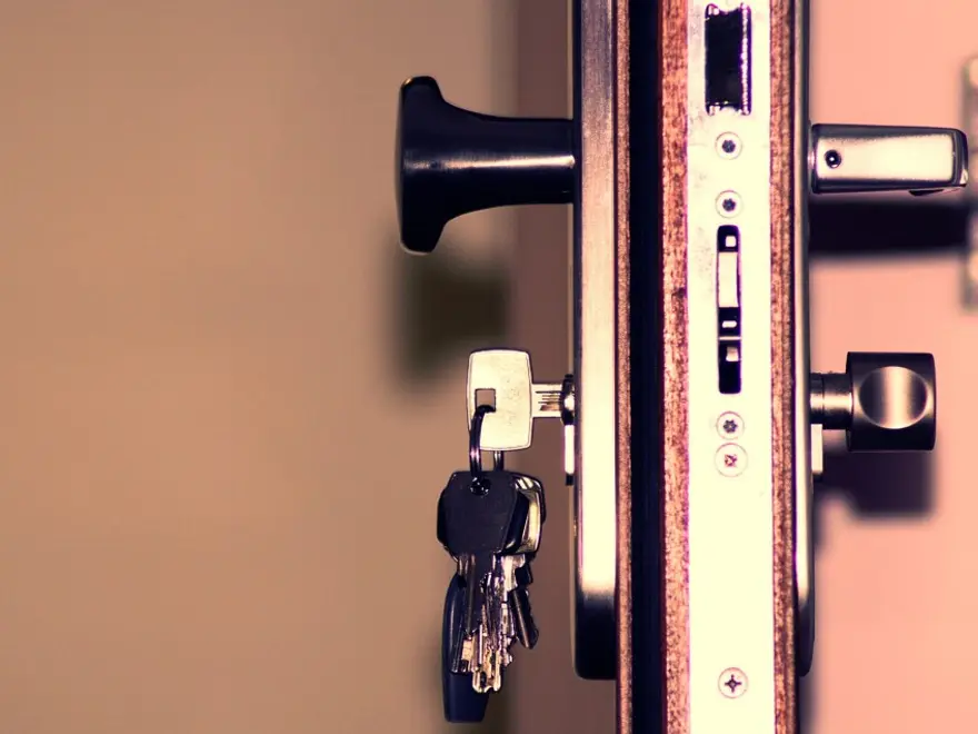 Keys hanging from a lock in a door