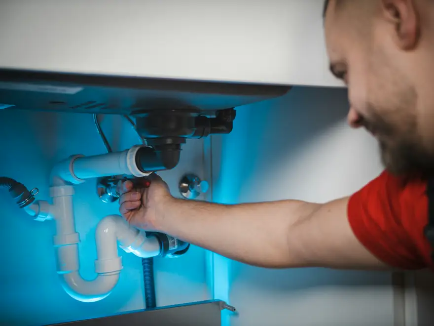 Plumber tightening a fitting on a copper pipe
