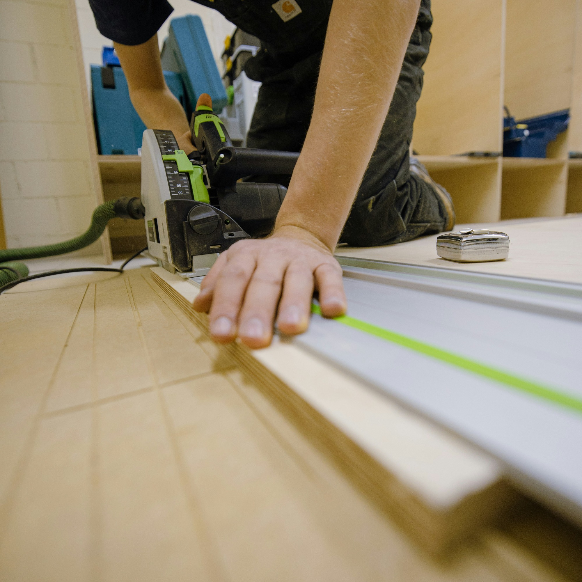 Carpenter cutting timber